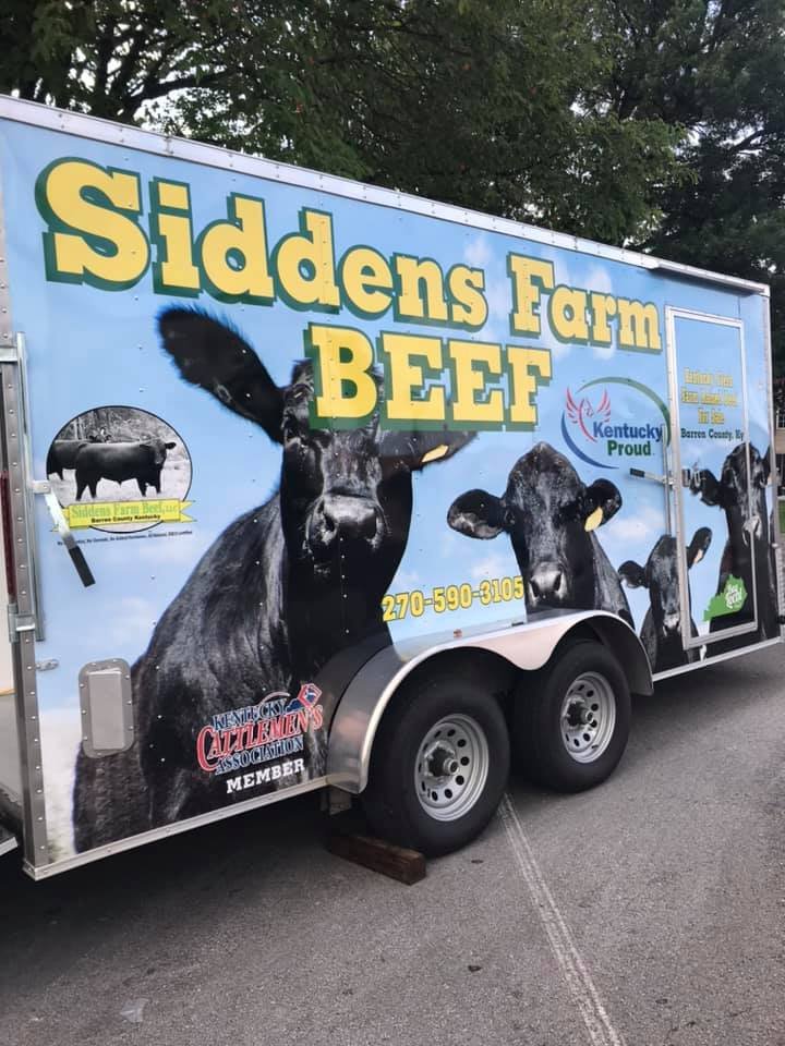 truck Siddens Farm Beef trailer showcasing black cattle images, promoting locally sourced beef in Kentucky. Contact information and membership with the Kentucky Cattlemen's Association visible.